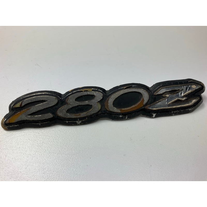 USED - AS SHOWN - Original OEM Rear Hatch ''280z'' Emblem For 1975-78 Datsun 280z